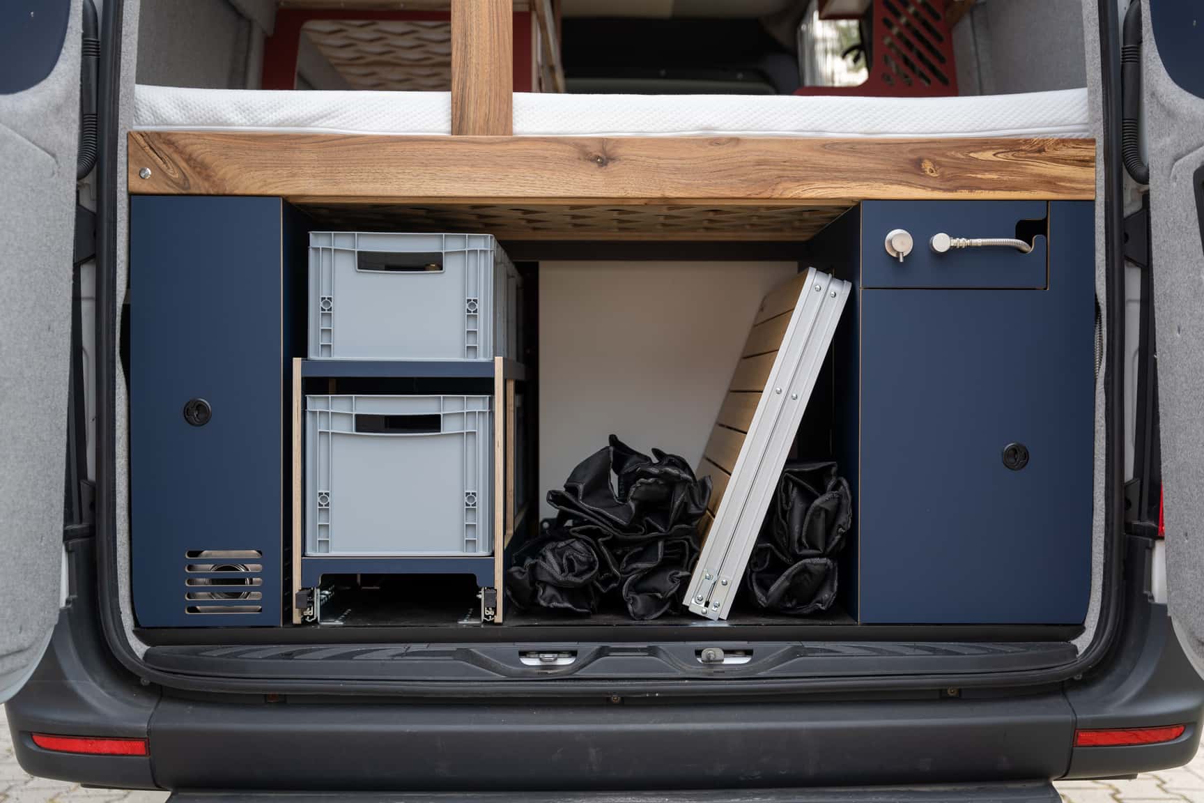 Rear storage with heavy-duty slide-out, electrical and gas cabinet in the Mercedes Sprinter L3H2 camper