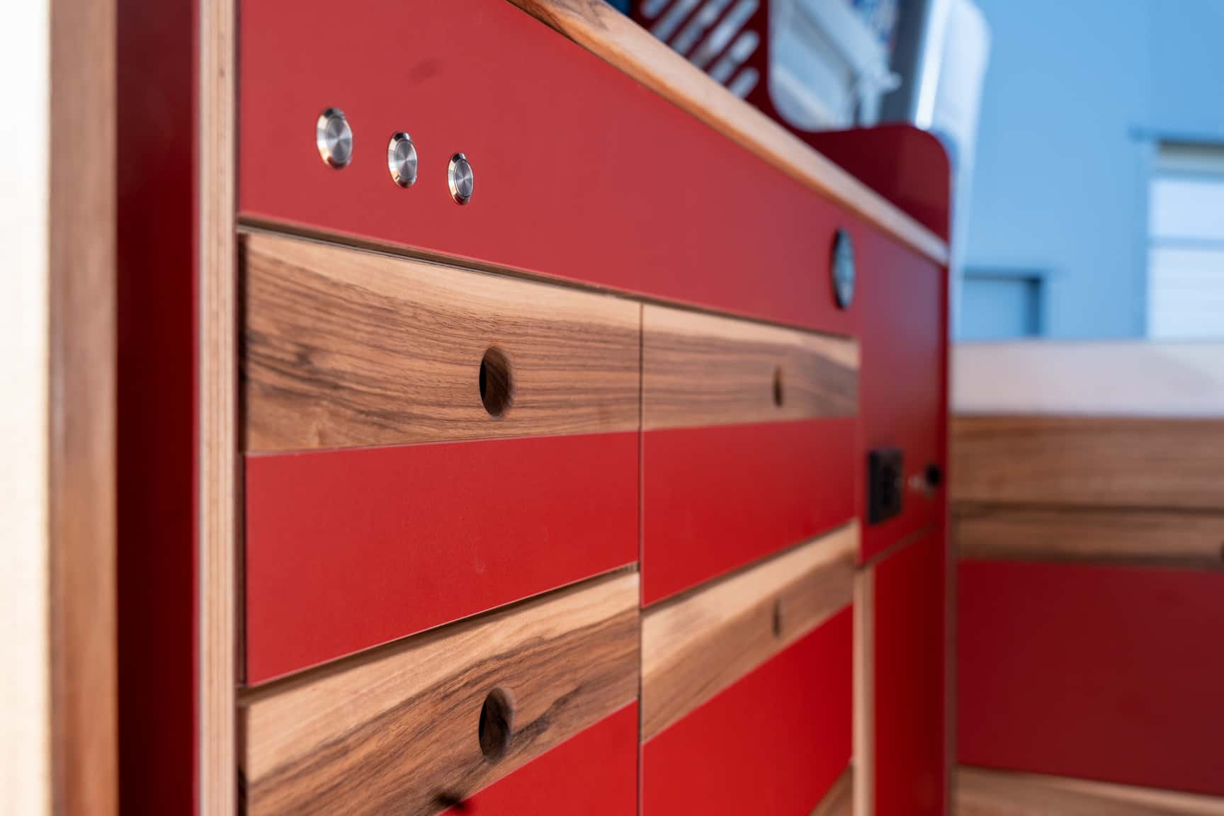 Cabinet fronts in walnut and red furniture linoleum in the kitchen run